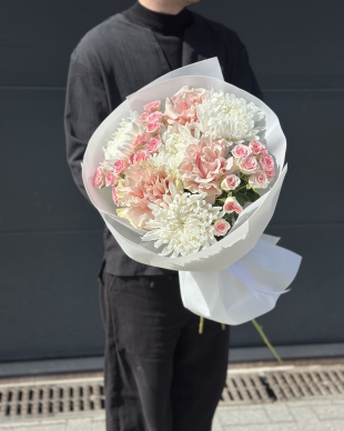 A beautiful bouquet of flowers featuring roses and chrysanthemums