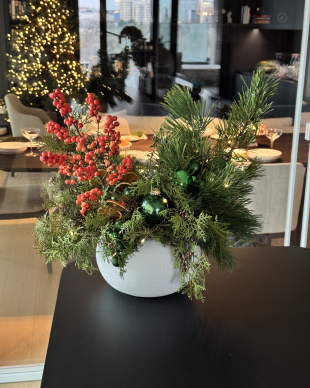 Christmas arrangement in white ceramic pot