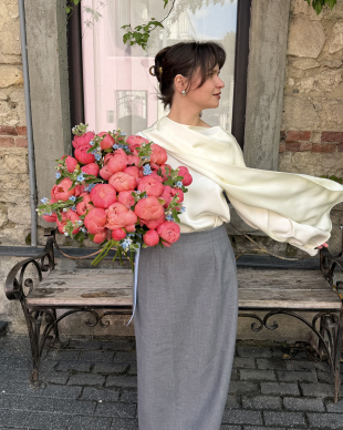 A bouquet of coral peonies and oxypitalum