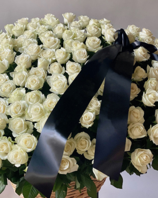 A mourning basket of white roses