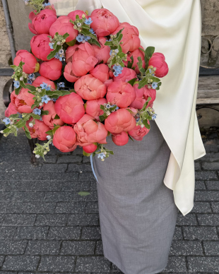 A bouquet of coral peonies and oxypitalum