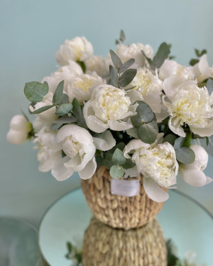 Basket with white peonies