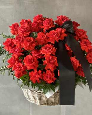 A mourning basket with red roses.