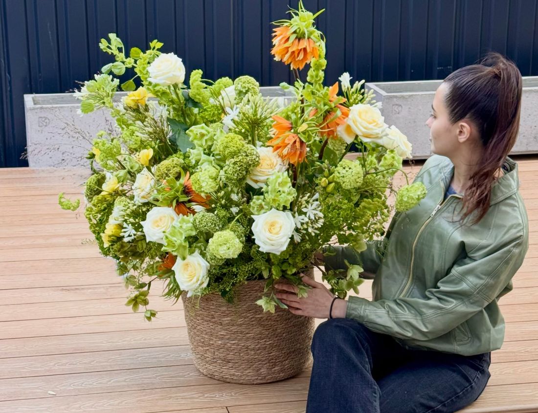 Luxurious flowers in a basket, delivered directly to the hands of the recipient.